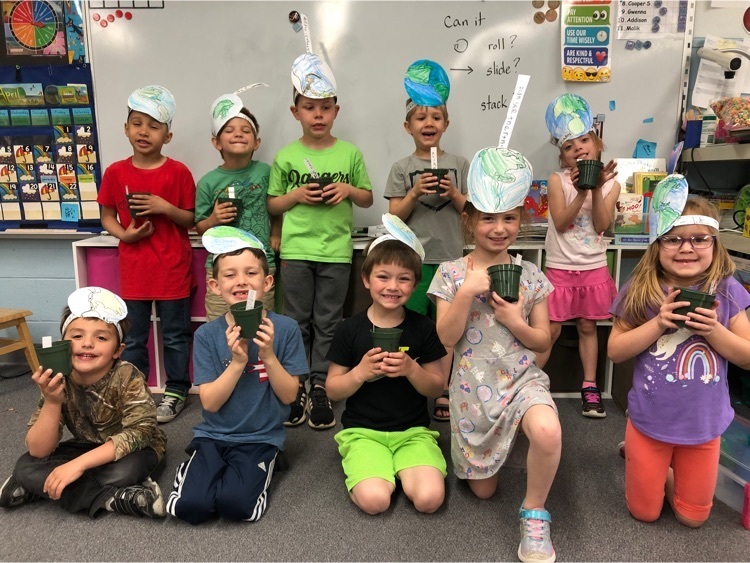 kindergarteners with homemade earth hats and pots with freshly planted corn