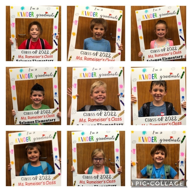 9 kids with a sign that says I am a kindergarten graduate!